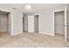 Spacious bedroom featuring neutral walls, carpet, modern lighting and convenient access to closet and hallway at 4262 Cloud Hopper Way, Lutz, FL 33559