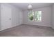Bright bedroom with carpet flooring, windows, and white trim at 4262 Cloud Hopper Way, Lutz, FL 33559