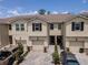 Charming townhome exterior featuring a one-car garage and well-maintained landscaping at 4262 Cloud Hopper Way, Lutz, FL 33559