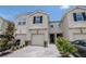 Charming townhome featuring a paved driveway, front lawn landscaping and an attached garage at 4262 Cloud Hopper Way, Lutz, FL 33559