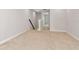Neutral colored hallway leading to an upstairs landing with stairs to another level at 4262 Cloud Hopper Way, Lutz, FL 33559