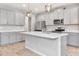 Modern kitchen featuring stainless steel appliances, an island, and ample cabinet space at 4262 Cloud Hopper Way, Lutz, FL 33559