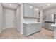 Bright kitchen with stainless steel fridge, a quartz countertop, and light wood-style floors at 4262 Cloud Hopper Way, Lutz, FL 33559