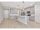Contemporary kitchen featuring an island, stainless appliances, and a view into other rooms at 4262 Cloud Hopper Way, Lutz, FL 33559