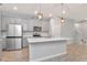 Bright kitchen showcasing stainless steel appliances, a central island, and modern pendant lighting at 4262 Cloud Hopper Way, Lutz, FL 33559