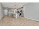 Open-concept kitchen with stainless steel appliances, center island, pendant lighting, and gray cabinets at 4262 Cloud Hopper Way, Lutz, FL 33559