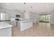 Open concept kitchen with stainless steel appliances and an island, connecting to the living area at 4262 Cloud Hopper Way, Lutz, FL 33559