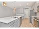 Stylish kitchen with stainless steel appliances, quartz counters, and a central island at 4262 Cloud Hopper Way, Lutz, FL 33559