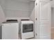 Efficient laundry room with modern front-load washer and dryer appliances at 4262 Cloud Hopper Way, Lutz, FL 33559