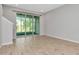 Open living room with wood-look tile flooring, recessed lighting, and sliding glass doors to a screened-in patio at 4262 Cloud Hopper Way, Lutz, FL 33559