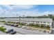 Aerial view of multi-unit apartment complex, parking lot, and lush landscaping at 4748 Azalea Dr # 204, New Port Richey, FL 34652