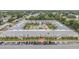 Aerial of a condo community featuring a central courtyard with pool, shuffleboard, and well-maintained landscaping at 4748 Azalea Dr # 204, New Port Richey, FL 34652