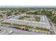 Aerial view showcasing the apartment's central courtyard with pool, shuffleboard, lush landscaping and mature trees at 4748 Azalea Dr # 204, New Port Richey, FL 34652