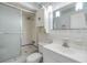 A full bathroom offers a single sink, a shower with glass doors, and a mirrored vanity for a cozy and functional space at 4748 Azalea Dr # 204, New Port Richey, FL 34652
