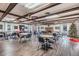 Spacious clubhouse area with tables, chairs, a brick fireplace, and a festive Christmas tree at 4748 Azalea Dr # 204, New Port Richey, FL 34652