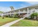 Well-maintained condominium exterior with a walkway, stairs, and landscaped lawn at 4748 Azalea Dr # 204, New Port Richey, FL 34652
