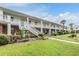 Low angle view of apartment building with brick facade and stairway at 4748 Azalea Dr # 204, New Port Richey, FL 34652