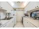 Efficient kitchen with bright cabinetry, essential appliances, and ample counter space, ideal for daily meal preparation at 4748 Azalea Dr # 204, New Port Richey, FL 34652