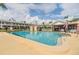 Relaxing community pool area featuring clear water, lounge chairs, and shade structures at 4748 Azalea Dr # 204, New Port Richey, FL 34652