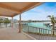 Expansive balcony with white railings and pillars, offering scenic views of the waterway and nearby buildings at 530 S Gulfview Blvd # 203, Clearwater Beach, FL 33767