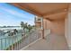 Spacious balcony with white railings offering stunning views of the waterway and nearby docks at 530 S Gulfview Blvd # 203, Clearwater Beach, FL 33767