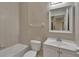 Cozy bathroom featuring a tile shower and tub, toilet, vanity with sink, and a large mirror at 530 S Gulfview Blvd # 203, Clearwater Beach, FL 33767