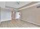 Spacious bedroom with hardwood floors, ceiling fan, and view into bathroom and hallway at 530 S Gulfview Blvd # 203, Clearwater Beach, FL 33767