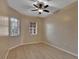 Bright bedroom featuring wood floors, neutral walls, a ceiling fan, and natural light from two windows at 530 S Gulfview Blvd # 203, Clearwater Beach, FL 33767