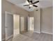 Neutral-toned bedroom featuring wood-look floors, ceiling fan, and paneled doors leading to other rooms at 530 S Gulfview Blvd # 203, Clearwater Beach, FL 33767