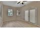 Bright and airy bedroom with wood-look floors, ceiling fan, and large windows at 530 S Gulfview Blvd # 203, Clearwater Beach, FL 33767