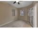 Bright bedroom featuring wood floors, neutral walls, a ceiling fan, and natural light from three windows at 530 S Gulfview Blvd # 203, Clearwater Beach, FL 33767
