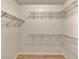 Walk-in closet with shelves and hardwood floors at 530 S Gulfview Blvd # 203, Clearwater Beach, FL 33767