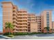 Stunning multi-story condo building with parking and beautiful landscaping and a vibrant architectural design at 530 S Gulfview Blvd # 203, Clearwater Beach, FL 33767