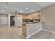 Open kitchen featuring light wood cabinets, marble countertops, and stainless steel appliances at 530 S Gulfview Blvd # 203, Clearwater Beach, FL 33767