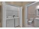 Laundry room with washer and dryer next to the downstairs bathroom at 530 S Gulfview Blvd # 203, Clearwater Beach, FL 33767