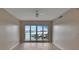 Airy living room with sliding doors to the balcony with amazing waterfront views and modern ceiling fan at 530 S Gulfview Blvd # 203, Clearwater Beach, FL 33767