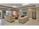 Relaxing resident lounge area with comfortable seating, television, and sliding doors to an outside balcony at 530 S Gulfview Blvd # 203, Clearwater Beach, FL 33767
