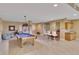 Large recreation room featuring a pool table, wet bar, comfortable seating, and bathroom access at 530 S Gulfview Blvd # 203, Clearwater Beach, FL 33767