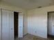 A bedroom featuring neutral walls, closet with louvered doors, and wall outlet at 5707 S 79Th St, Tampa, FL 33619
