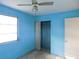 Bright blue bedroom with closet, door and window at 5707 S 79Th St, Tampa, FL 33619