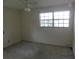 The bedroom features a ceiling fan, large window, and neutral walls at 5707 S 79Th St, Tampa, FL 33619