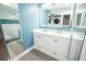 Modern bathroom featuring a dual sink vanity, illuminated mirror, and a tiled glass enclosed shower at 5712 Biscayne Ct # 201, New Port Richey, FL 34652