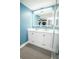 Modern bathroom featuring a dual sink vanity, illuminated mirror, and a tiled glass enclosed shower at 5712 Biscayne Ct # 201, New Port Richey, FL 34652