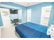 Bright bedroom featuring a comfortable bed, sleek flooring, and calming blue accent wall at 5712 Biscayne Ct # 201, New Port Richey, FL 34652