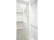 Well-organized walk-in closet with ample storage space, shelves, and hanging rods at 5712 Biscayne Ct # 201, New Port Richey, FL 34652