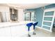 Kitchen island with quartz countertop, modern appliances, light fixtures and blue bar stools at 5712 Biscayne Ct # 201, New Port Richey, FL 34652