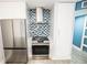 Contemporary kitchen design features stainless steel appliances and stylish backsplash at 5712 Biscayne Ct # 201, New Port Richey, FL 34652