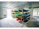 Indoor storage room with multiple kayaks and paddleboards stacked on racks at 5712 Biscayne Ct # 201, New Port Richey, FL 34652