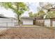 Fenced backyard with green spaces and storage sheds at 5801 N 17Th St, Tampa, FL 33610