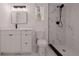 Bathroom featuring a tiled walk-in shower, vanity, a sleek framed mirror, and matching toilet at 5801 N 17Th St, Tampa, FL 33610
